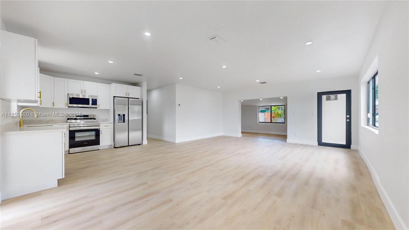 Empty room, Interior, Kitchen, Recessed Lighting, Stainless Steel Appliances, Wood Texture Flooring