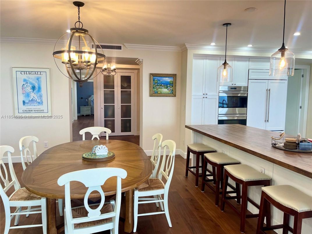 Chandelier, Dining room, Interior, Kitchen, Pendant Lights, Recessed Lighting, Stainless Steel Appliances, Wood Texture Flooring