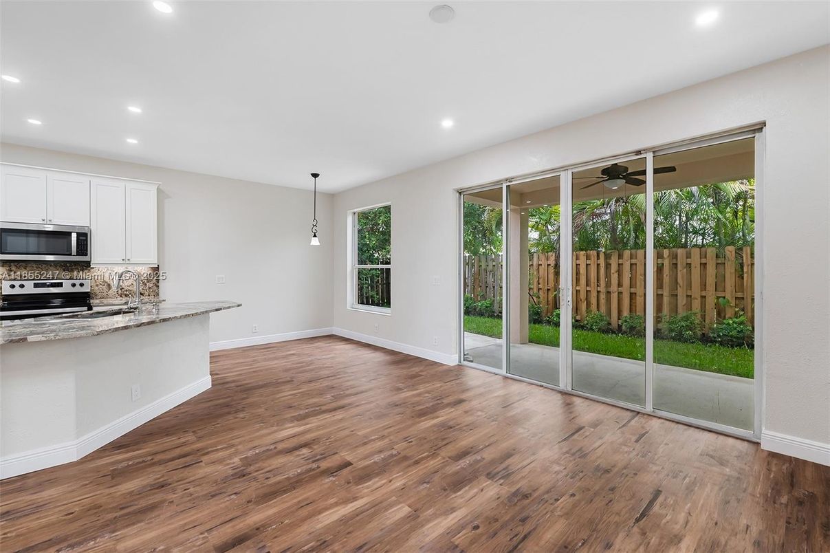 Empty room, Interior, Kitchen, Pendant Lights, Recessed Lighting, Stainless Steel Appliances, Wood Texture Flooring