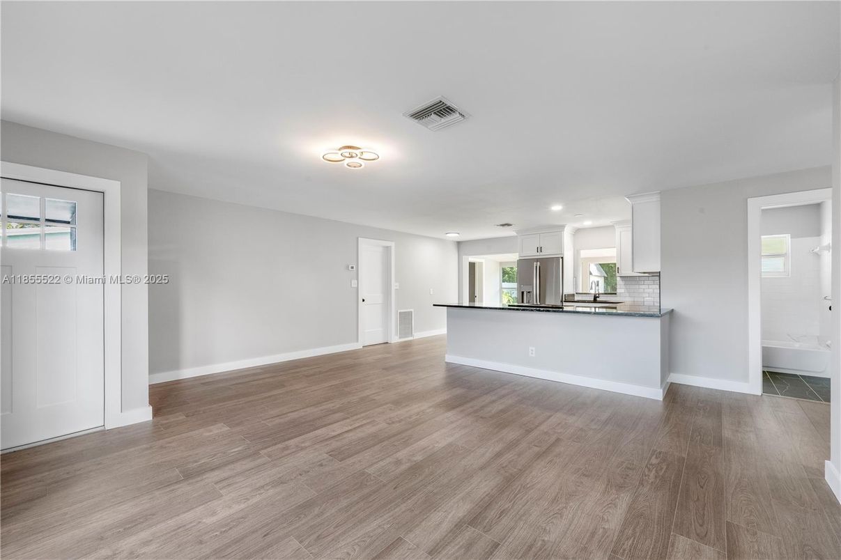 Empty room, Interior, Kitchen, Recessed Lighting, Stainless Steel Appliances, Wood Texture Flooring