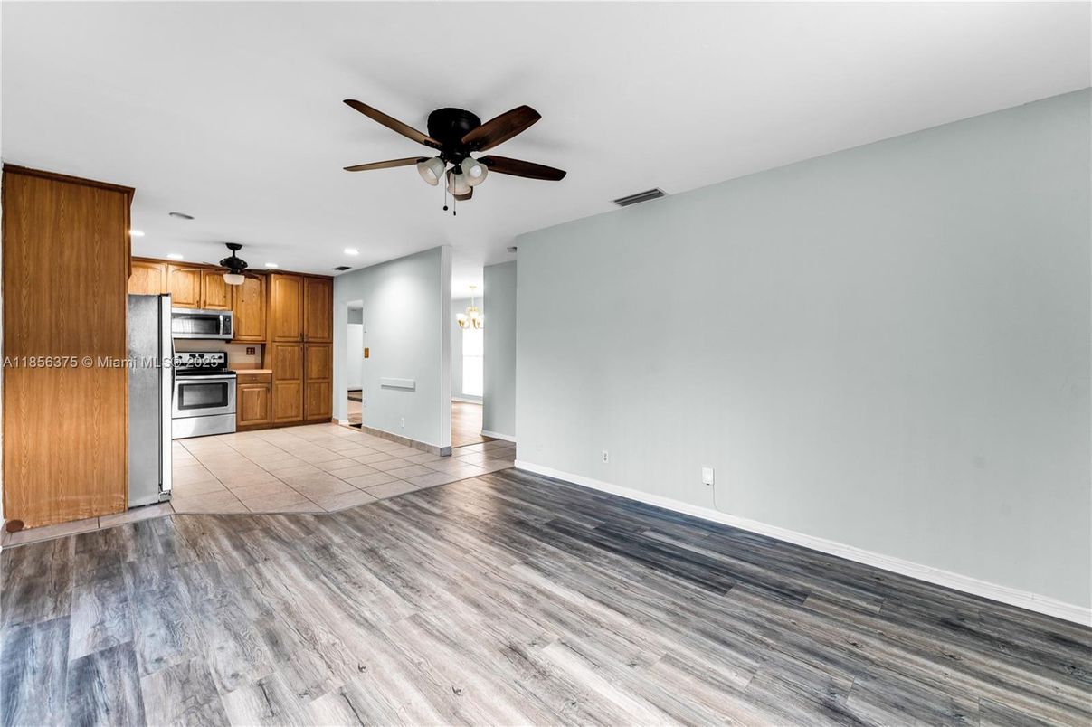 Empty room, Interior, Kitchen, Recessed Lighting, Stainless Steel Appliances, Wood Texture Flooring