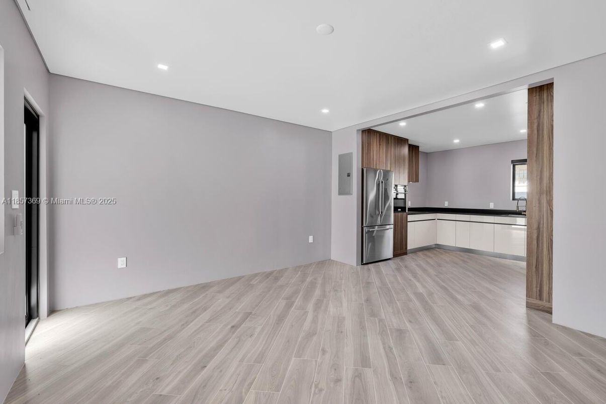 Empty room, Interior, Kitchen, Recessed Lighting, Stainless Steel Appliances, Wood Texture Flooring