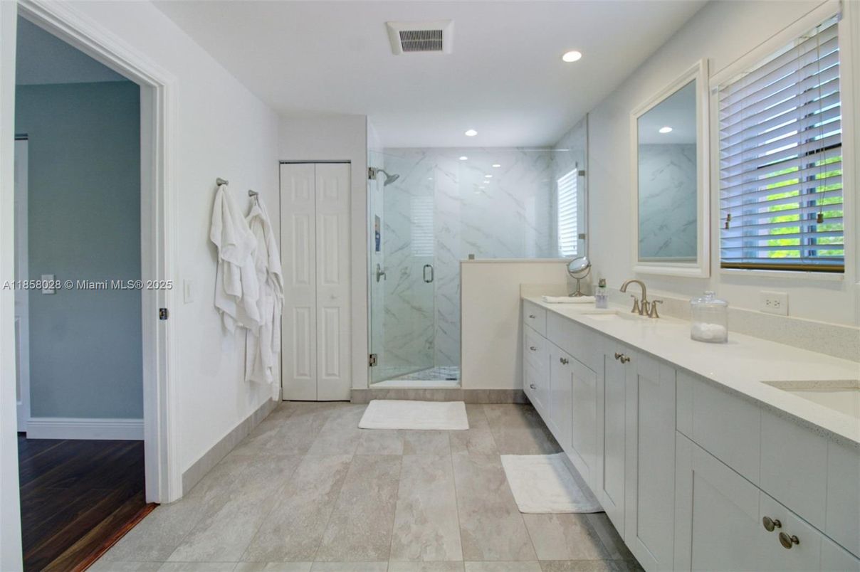 Bathroom, Dual Sink Vanities, Glass Shower, Interior, Marble Walls, Recessed Lighting, Wood Texture Flooring