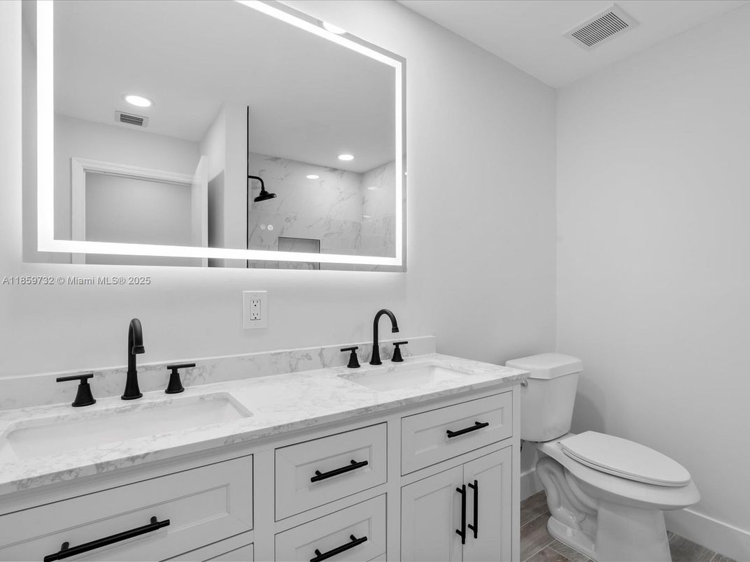 Bathroom, Dual Sink Vanities, Interior, Marble Walls, Recessed Lighting, Wood Texture Flooring