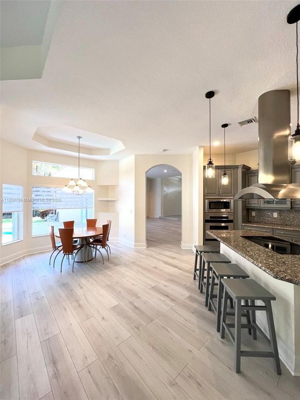 Chandelier, Dining room, Interior, Kitchen, Pendant Lights, Stainless Steel Appliances, Wood Texture Flooring