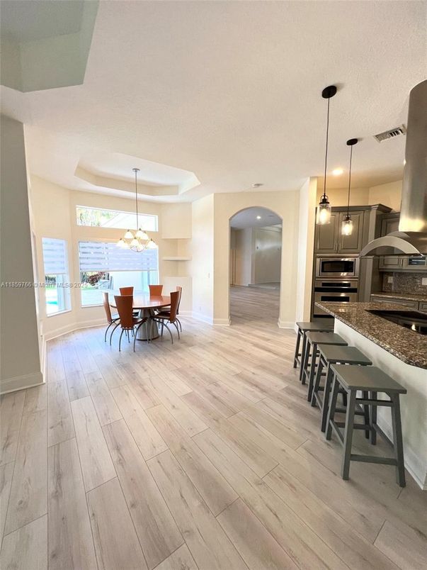 Chandelier, Dining room, Interior, Kitchen, Pendant Lights, Recessed Lighting, Stainless Steel Appliances, Wood Texture Flooring