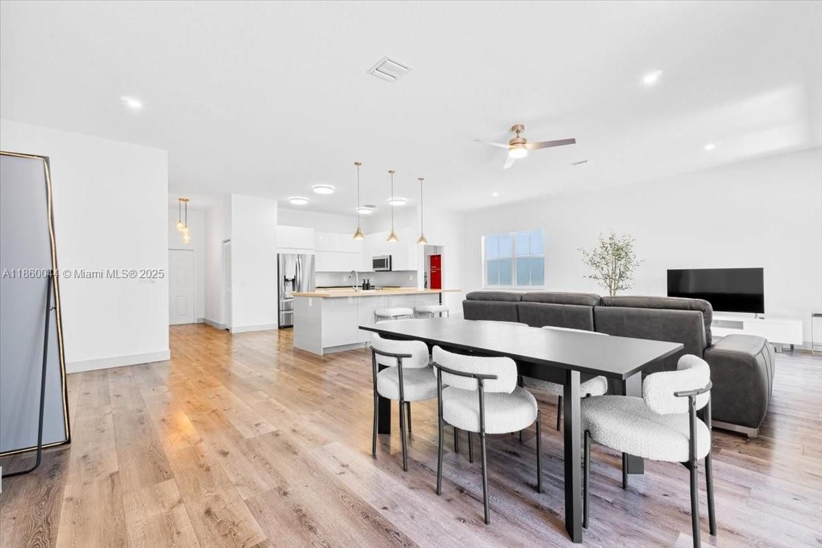 Dining room, Interior, Kitchen, Living room, Pendant Lights, Recessed Lighting, Stainless Steel Appliances, Wood Texture Flooring