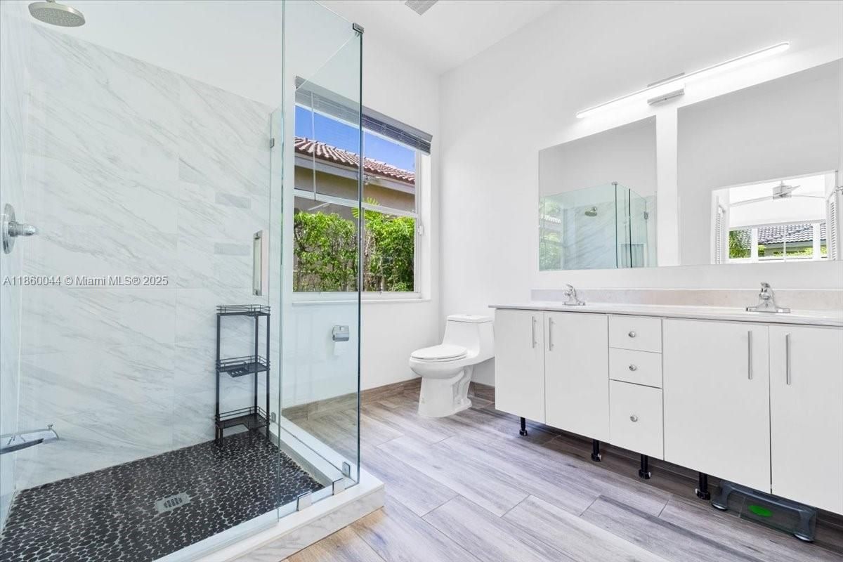 Bathroom, Dual Sink Vanities, Glass Shower, Interior, Marble Walls, Wood Texture Flooring