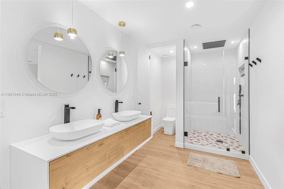 Bathroom, Dual Sink Vanities, Glass Shower, Interior, Pendant Lights, Recessed Lighting, Wood Texture Flooring