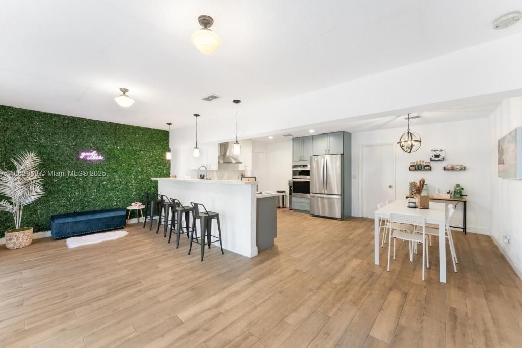 Dining room, Interior, Kitchen, Pendant Lights, Recessed Lighting, Stainless Steel Appliances, Wood Texture Flooring