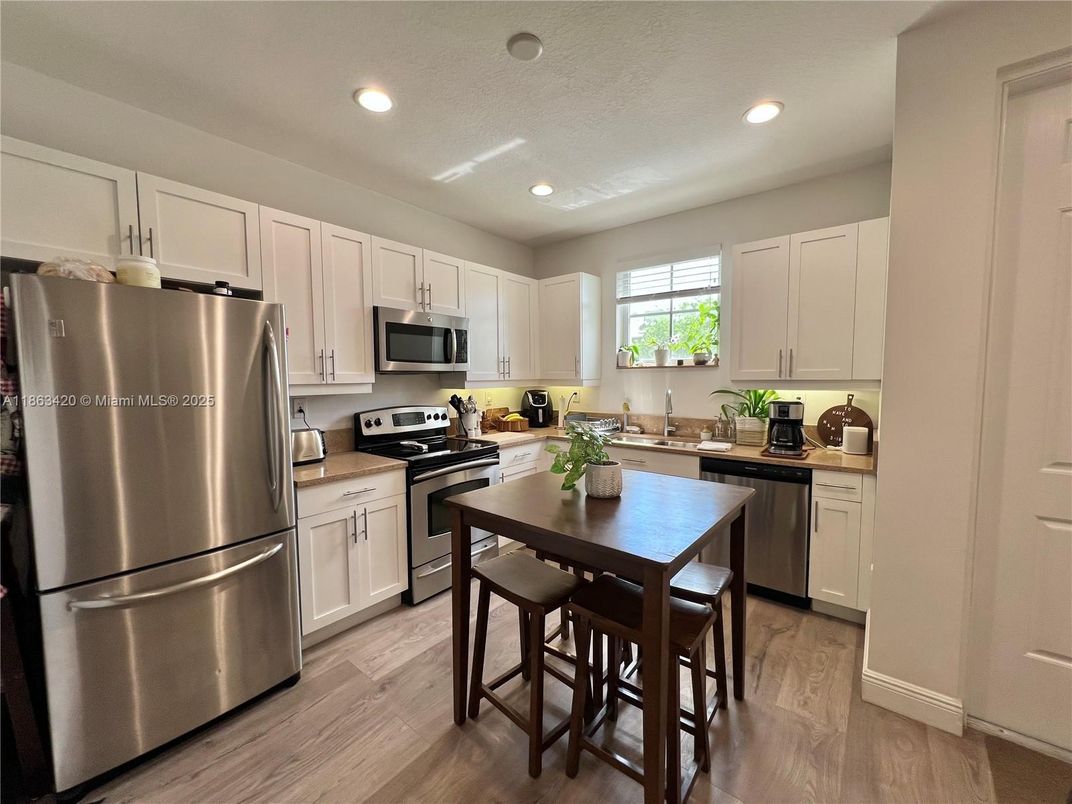 Dining room, Interior, Kitchen, Recessed Lighting, Stainless Steel Appliances, Wood Texture Flooring