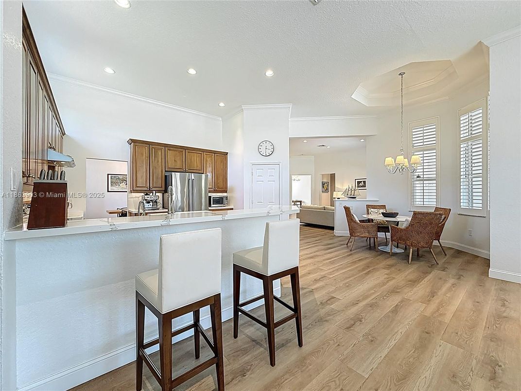 Chandelier, Dining room, Interior, Kitchen, Pendant Lights, Recessed Lighting, Stainless Steel Appliances, Wood Texture Flooring