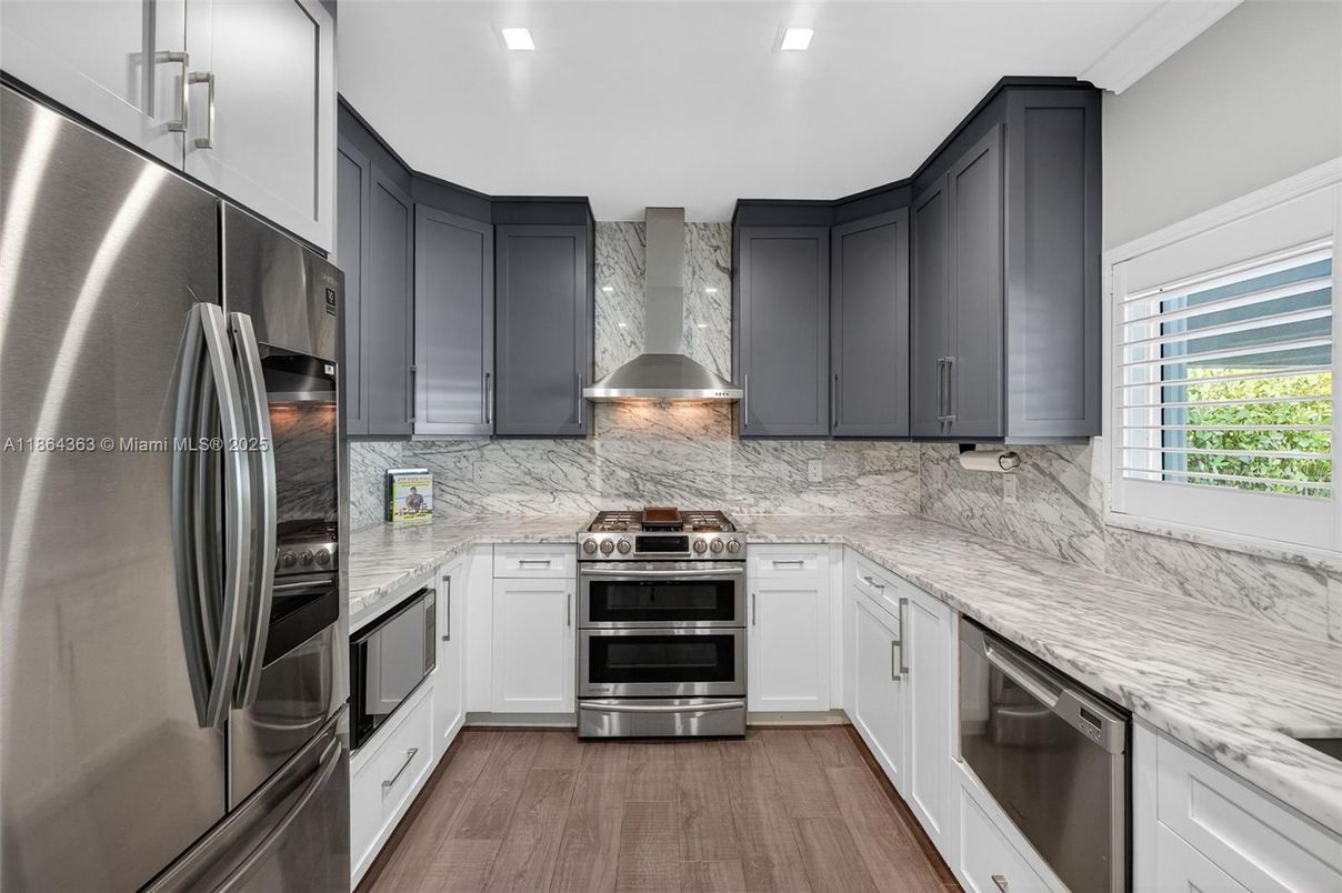 Interior, Kitchen, Marble Walls, Recessed Lighting, Stainless Steel Appliances, Wood Texture Flooring