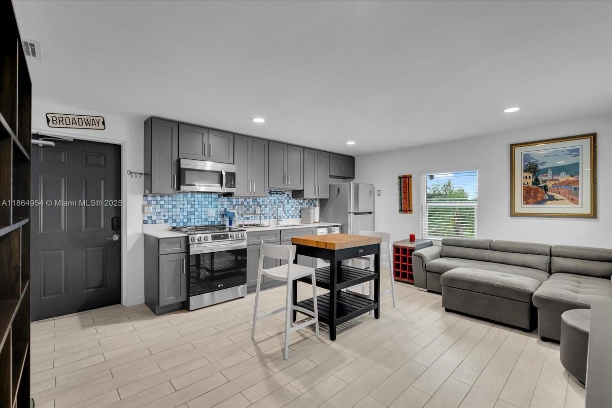 Dining room, Interior, Kitchen, Living room, Recessed Lighting, Stainless Steel Appliances, Wood Texture Flooring