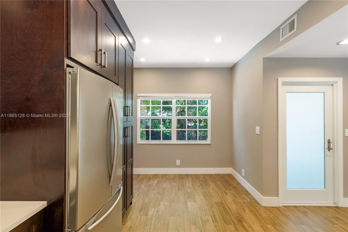 Empty room, Interior, Kitchen, Recessed Lighting, Stainless Steel Appliances, Wood Texture Flooring