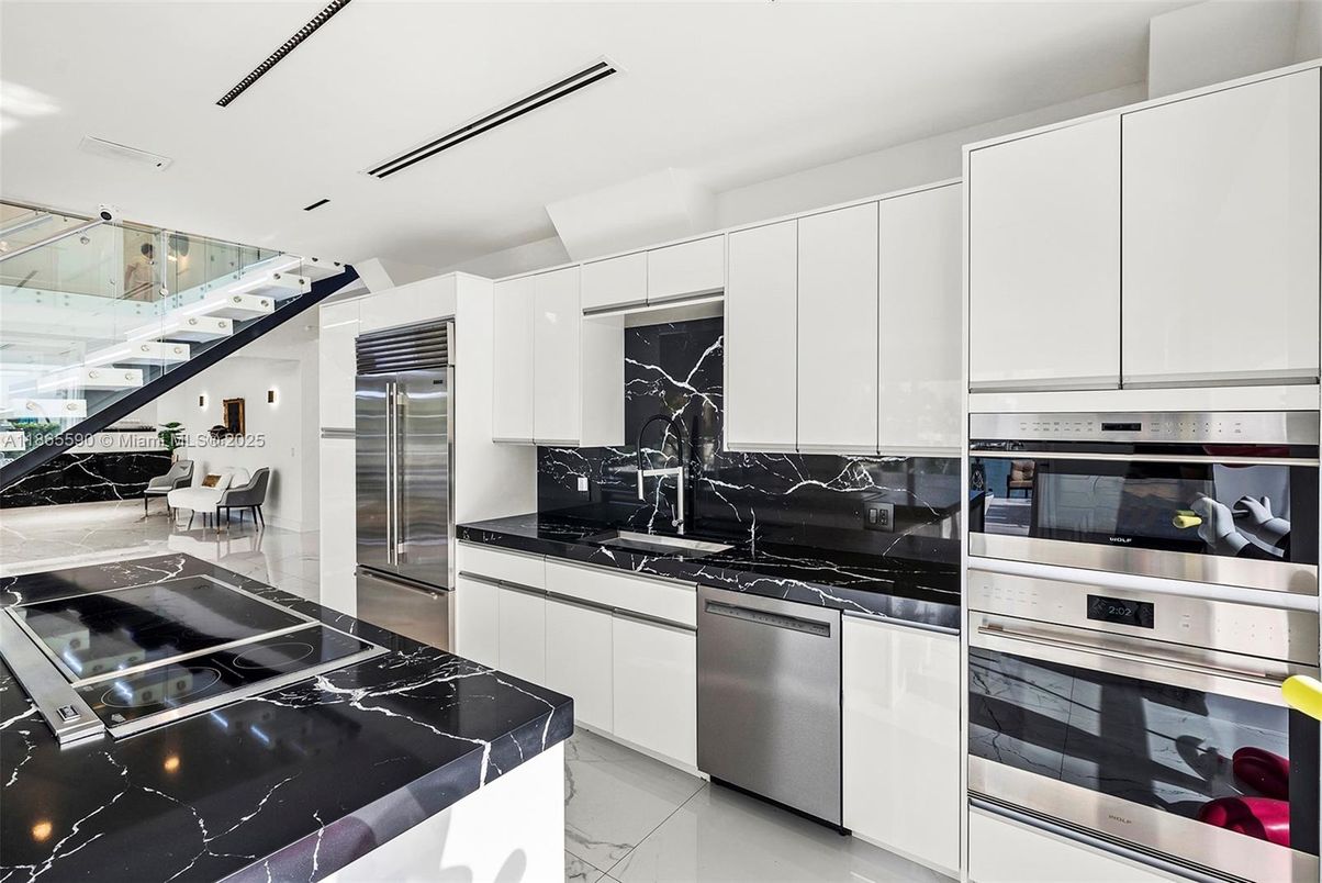 Interior, Kitchen, Marble Walls, Recessed Lighting, Stainless Steel Appliances
