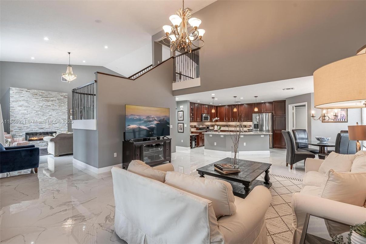Chandelier, Dining room, Fireplace, Interior, Kitchen, Living room, Marble, Pendant Lights, Recessed Lighting, Stainless Steel Appliances, Stone Walls