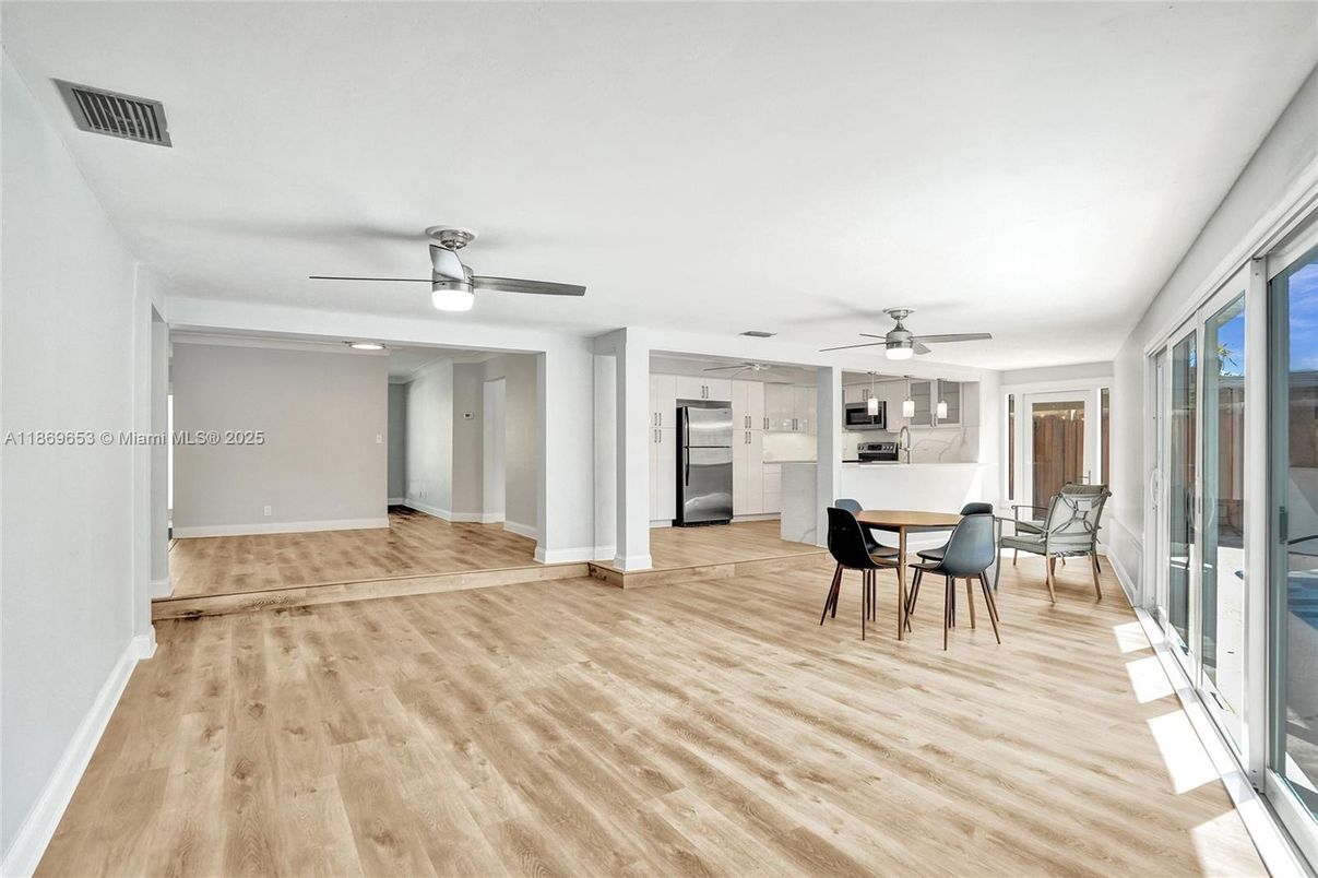 Dining room, Empty room, Interior, Kitchen, Recessed Lighting, Stainless Steel Appliances, Wood Texture Flooring
