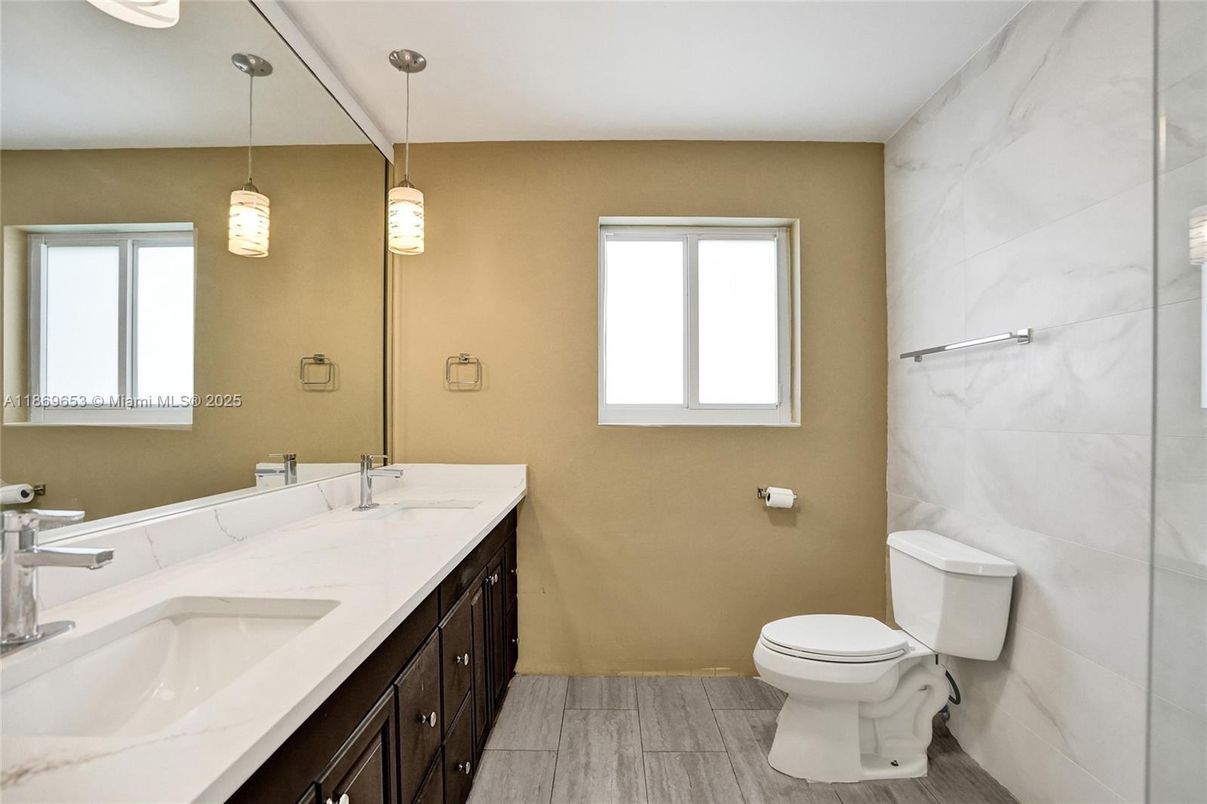 Bathroom, Dual Sink Vanities, Interior, Marble Walls, Pendant Lights, Wood Texture Flooring