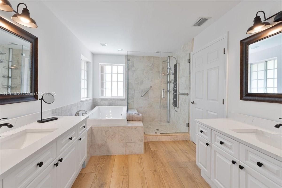 Bathroom, Dual Sink Vanities, Glass Shower, Interior, Recessed Lighting, Wood Texture Flooring