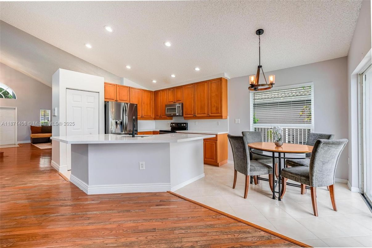 Chandelier, Dining room, Interior, Kitchen, Pendant Lights, Recessed Lighting, Stainless Steel Appliances, Wood Texture Flooring