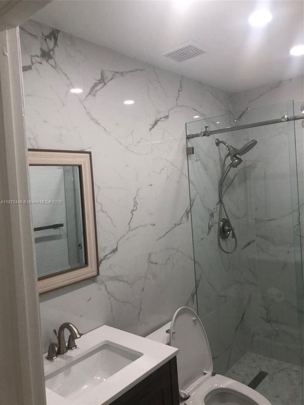 Bathroom, Dual Sink Vanities, Glass Shower, Interior, Marble Walls, Recessed Lighting