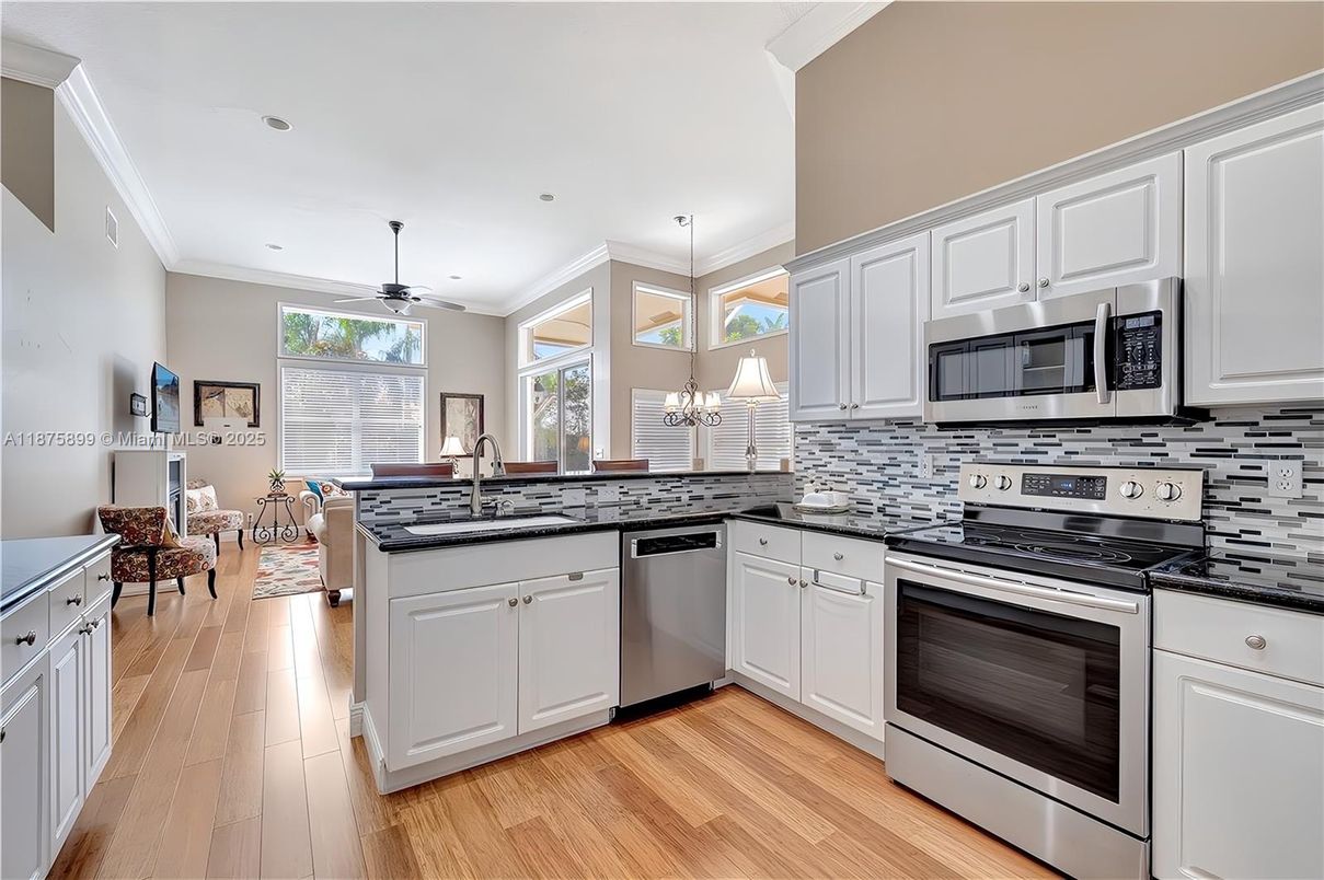 Dining room, Interior, Kitchen, Pendant Lights, Recessed Lighting, Stainless Steel Appliances, Wood Texture Flooring
