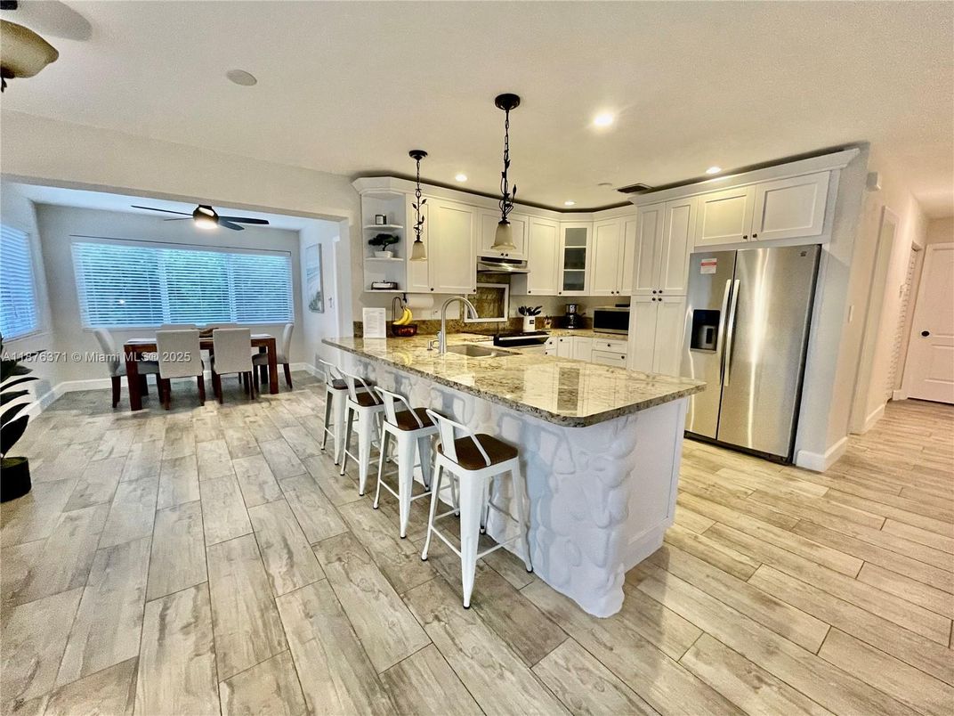 Dining room, Interior, Kitchen, Pendant Lights, Recessed Lighting, Stainless Steel Appliances, Wood Texture Flooring