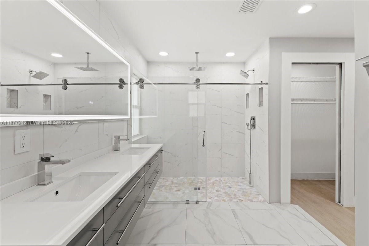 Bathroom, Dual Sink Vanities, Glass Shower, Interior, Marble, Marble Walls, Recessed Lighting, Wood Texture Flooring