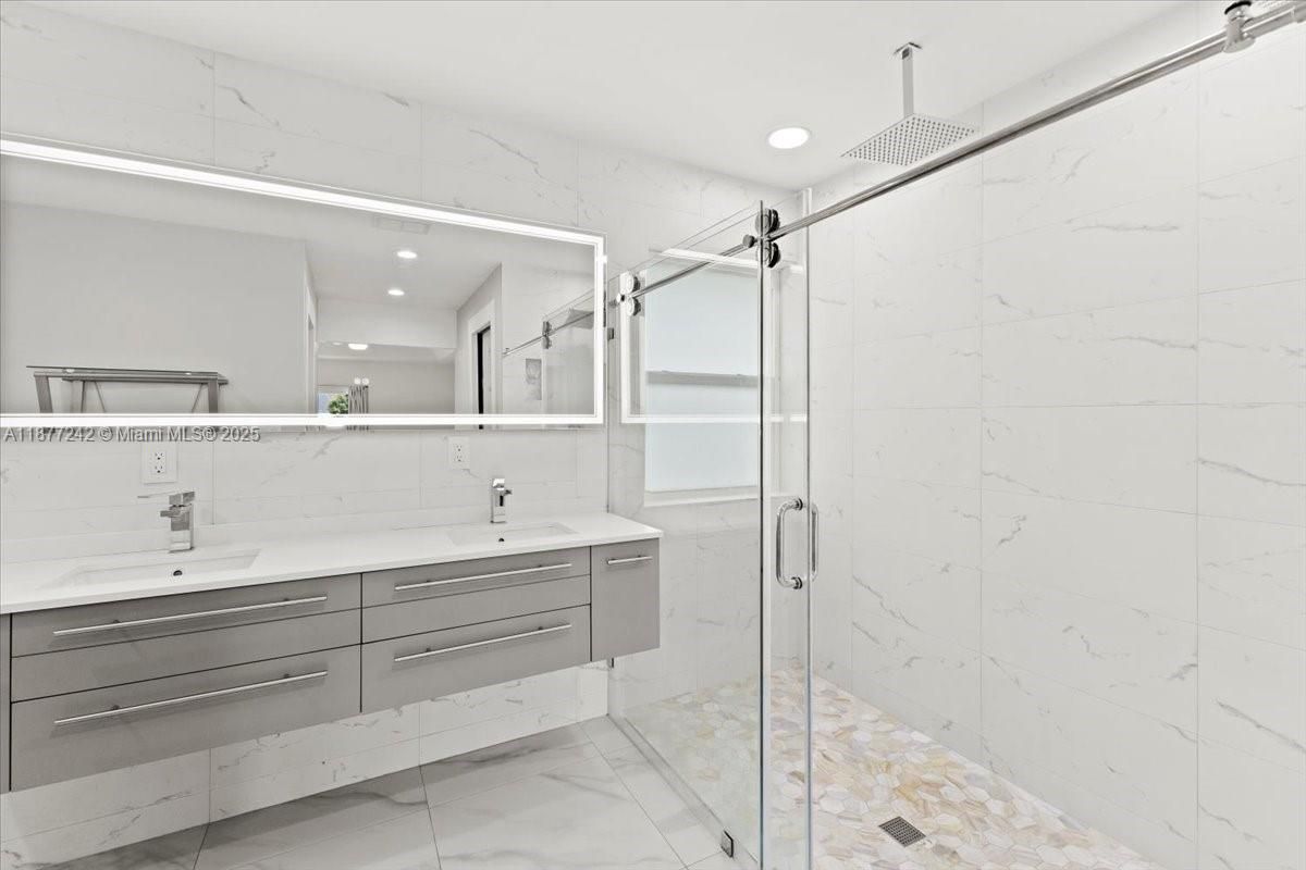 Bathroom, Dual Sink Vanities, Glass Shower, Interior, Marble, Marble Walls, Recessed Lighting