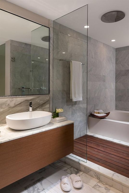 Bathroom, Dual Sink Vanities, Glass Shower, Interior, Marble, Marble Walls, Recessed Lighting, Wood Texture Flooring