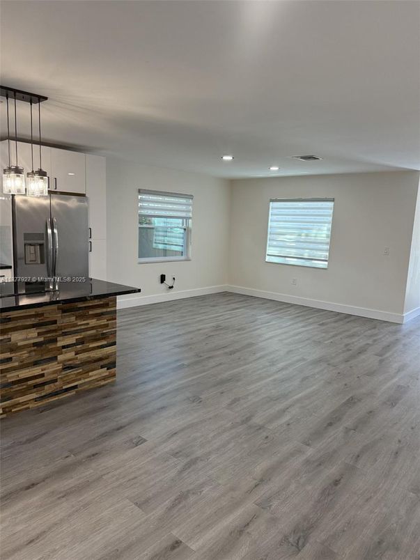 Empty room, Interior, Kitchen, Pendant Lights, Recessed Lighting, Stainless Steel Appliances, Wood Texture Flooring