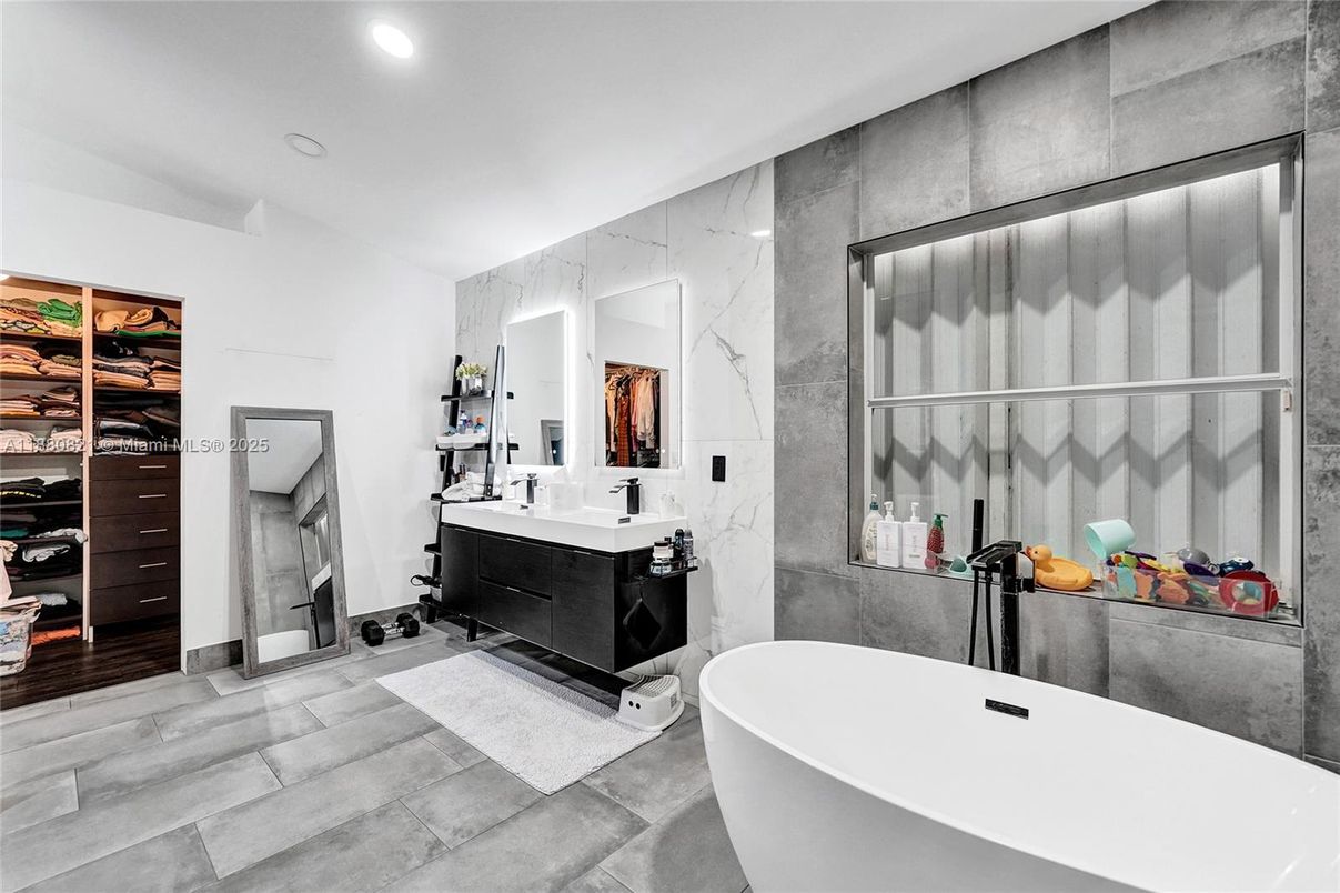Bathroom, Dual Sink Vanities, Free Standing Baths, Interior, Marble Walls, Recessed Lighting, Walk-in Closets, Wood Texture Flooring