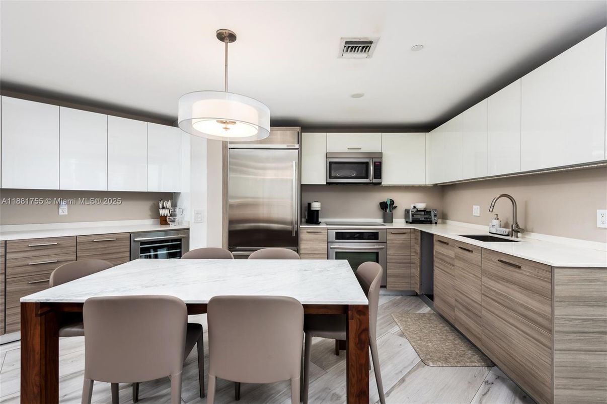 Dining room, Interior, Kitchen, Pendant Lights, Recessed Lighting, Stainless Steel Appliances, Wood Texture Flooring