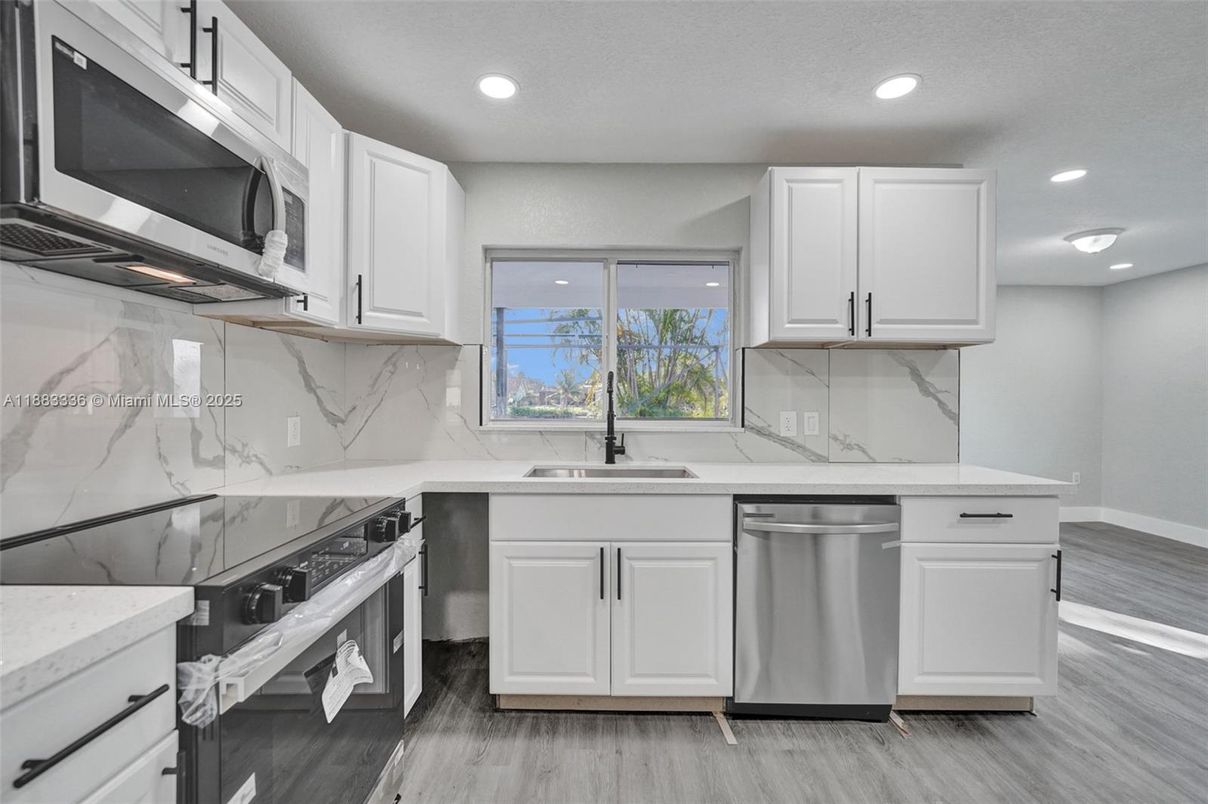 Interior, Kitchen, Marble Walls, Recessed Lighting, Stainless Steel Appliances, Wood Texture Flooring