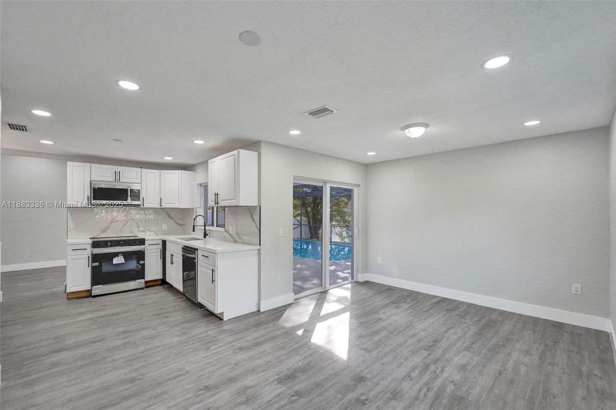Interior, Kitchen, Marble Walls, Recessed Lighting, Stainless Steel Appliances, Wood Texture Flooring