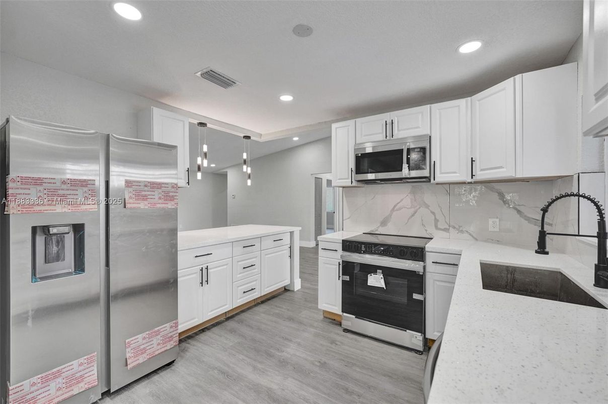 Interior, Kitchen, Marble Walls, Pendant Lights, Recessed Lighting, Stainless Steel Appliances, Wood Texture Flooring
