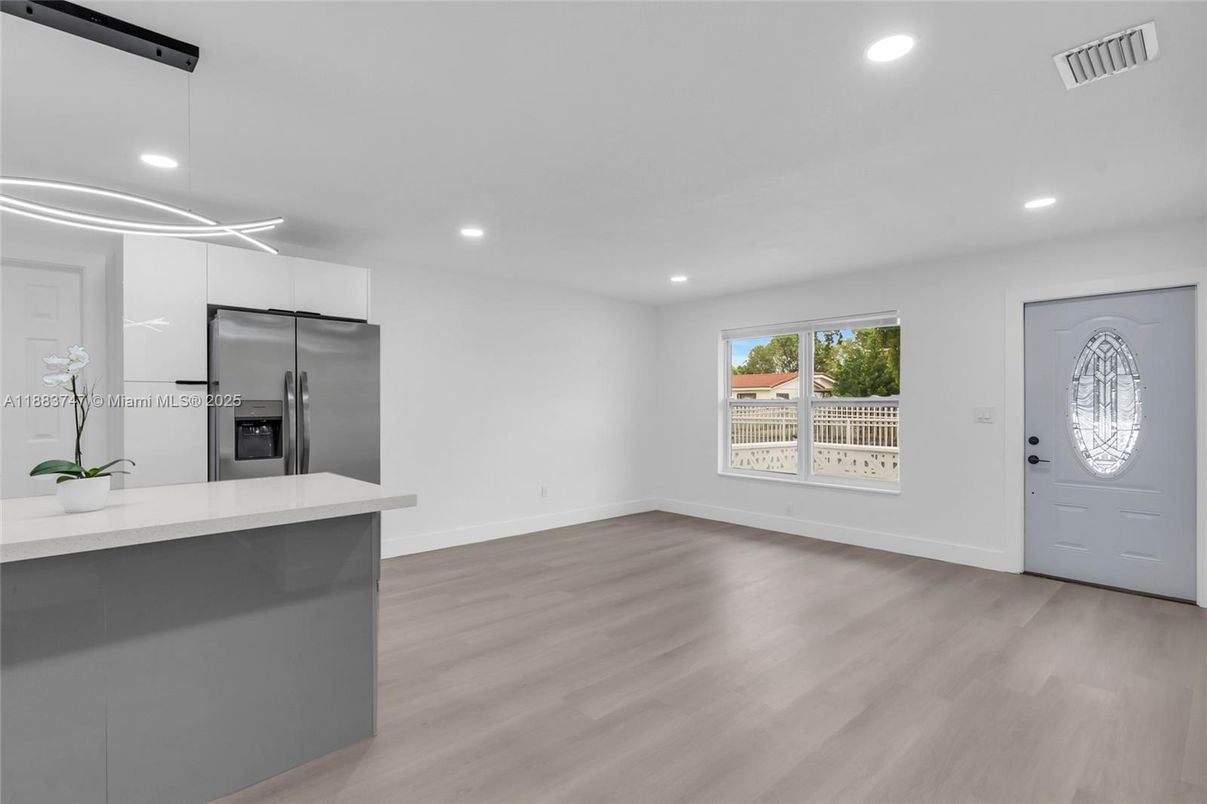 Empty room, Interior, Kitchen, Recessed Lighting, Stainless Steel Appliances, Wood Texture Flooring