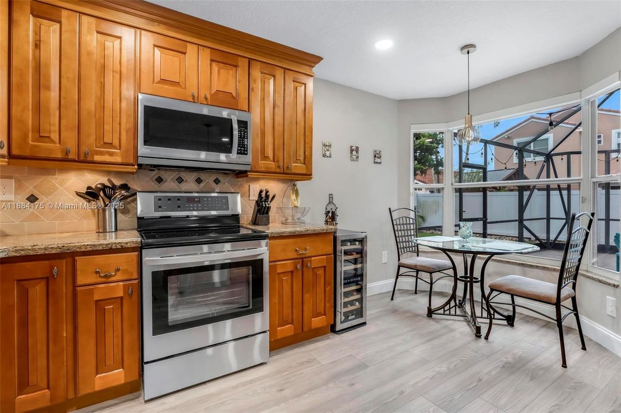 Chandelier, Dining room, Interior, Kitchen, Pendant Lights, Recessed Lighting, Stainless Steel Appliances, Wood Texture Flooring