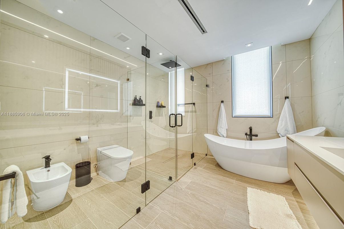 Bathroom, Dual Sink Vanities, Free Standing Baths, Glass Shower, Interior, Recessed Lighting, Wood Texture Flooring