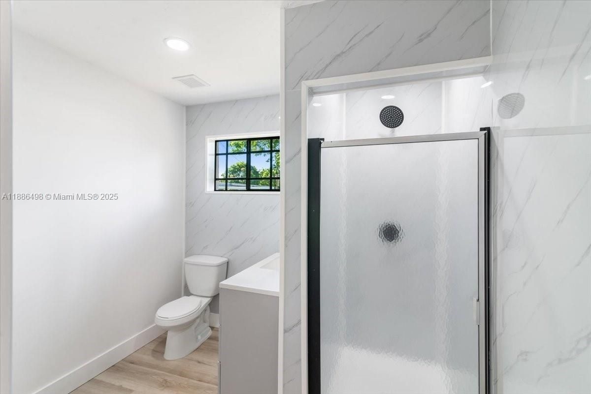 Bathroom, Glass Shower, Interior, Marble Walls, Recessed Lighting, Wood Texture Flooring