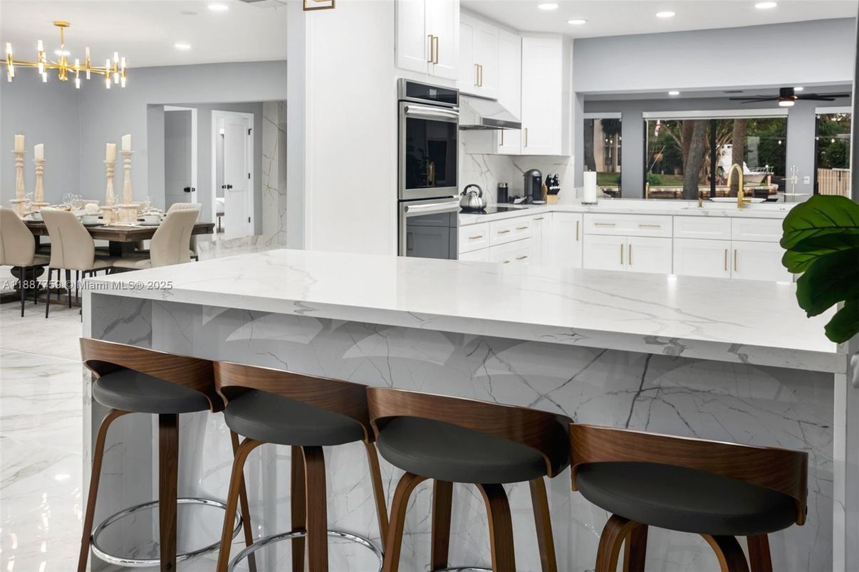 Dining room, Interior, Kitchen, Marble, Marble Walls, Pendant Lights, Recessed Lighting, Stainless Steel Appliances
