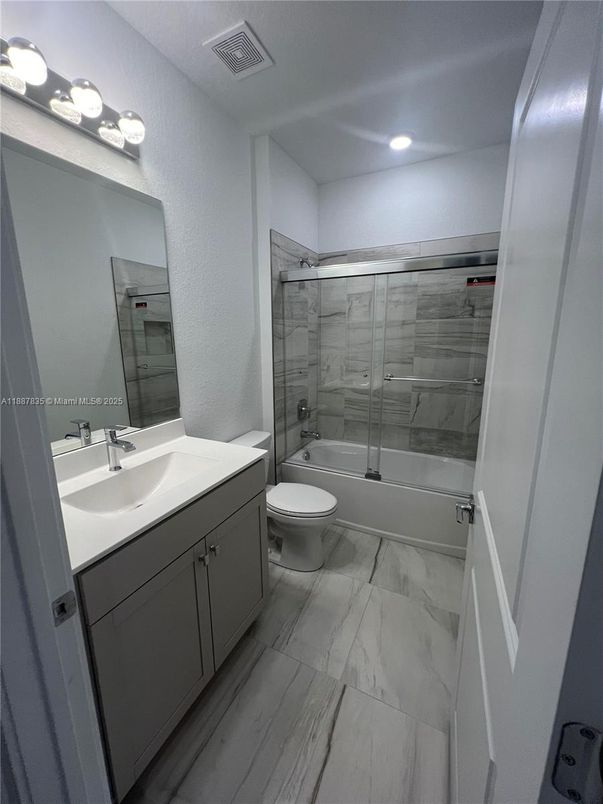 Bathroom, Dual Sink Vanities, Glass Shower, Interior, Marble, Recessed Lighting, Wood Texture Flooring