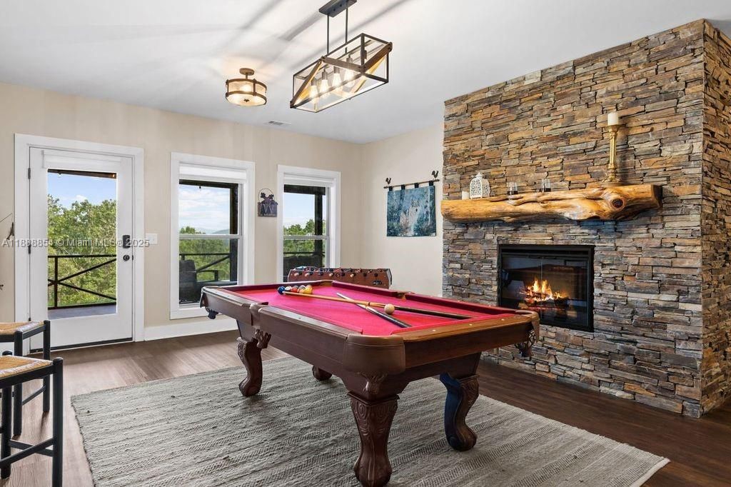 Billiard Table, Fireplace, Game Room, Interior, Pendant Lights, Stone Walls, Wood Texture Flooring