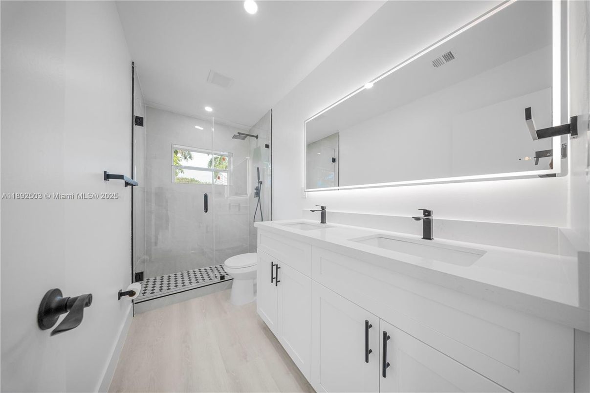 Bathroom, Dual Sink Vanities, Glass Shower, Interior, Recessed Lighting, Wood Texture Flooring