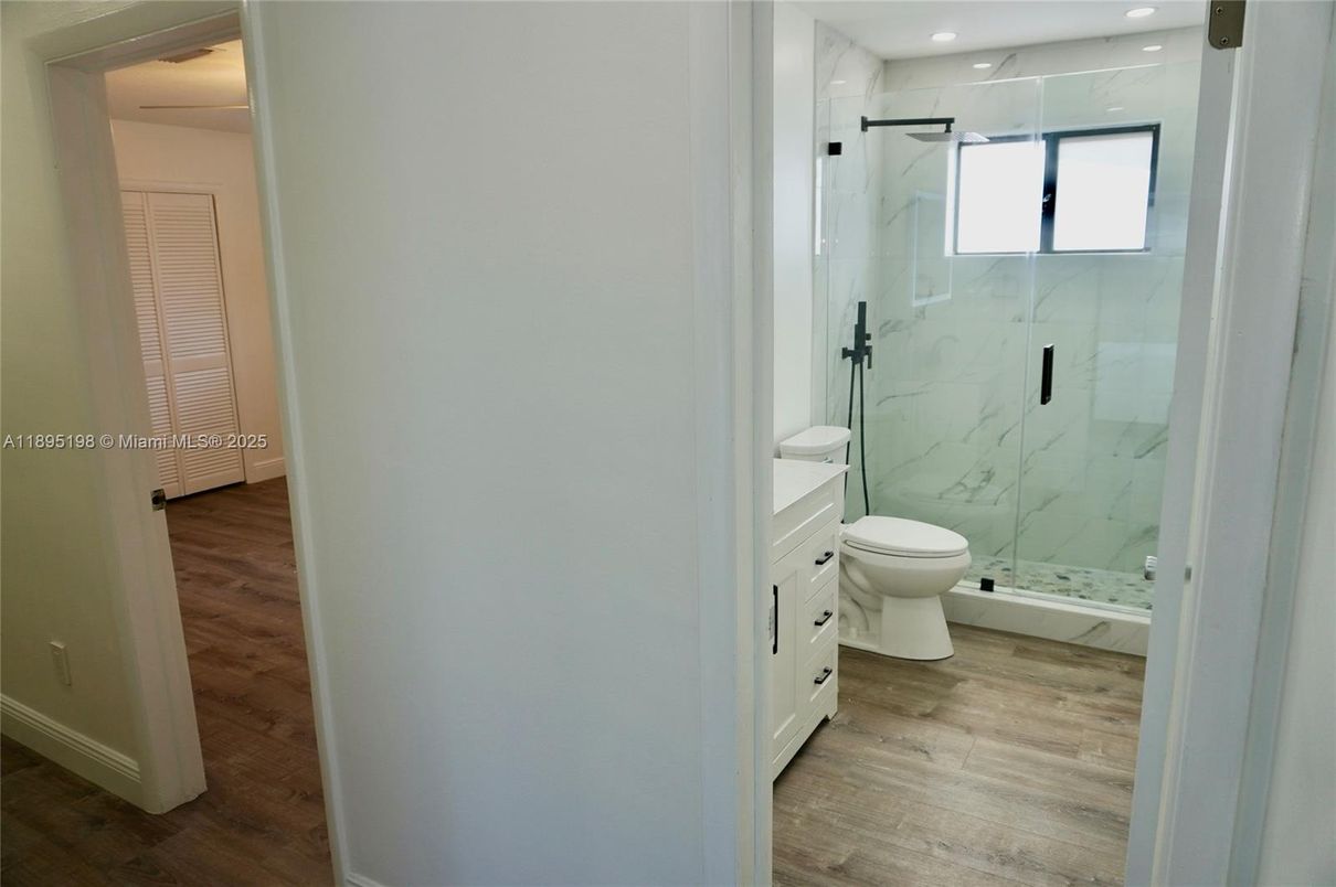 Bathroom, Glass Shower, Interior, Marble Walls, Recessed Lighting, Wood Texture Flooring