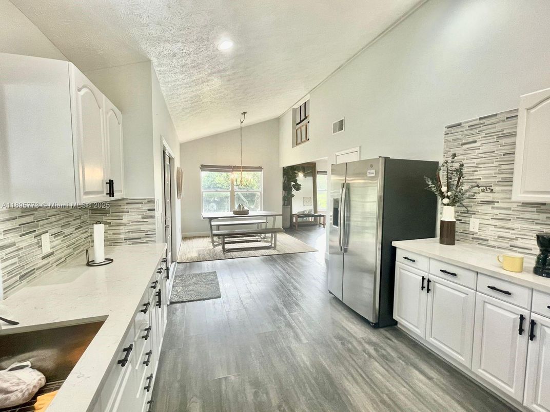 Dining room, Interior, Kitchen, Pendant Lights, Recessed Lighting, Stainless Steel Appliances, Wood Texture Flooring
