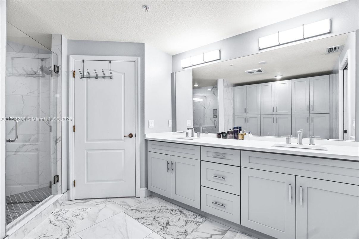 Bathroom, Dual Sink Vanities, Glass Shower, Interior, Marble, Marble Walls, Recessed Lighting