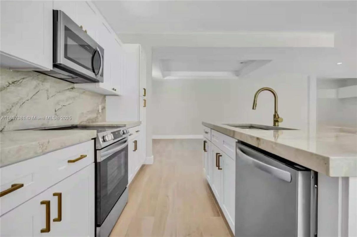 Interior, Kitchen, Marble Walls, Recessed Lighting, Stainless Steel Appliances, Wood Texture Flooring