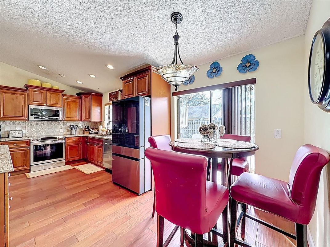 Dining room, Interior, Kitchen, Pendant Lights, Recessed Lighting, Stainless Steel Appliances, Wood Texture Flooring